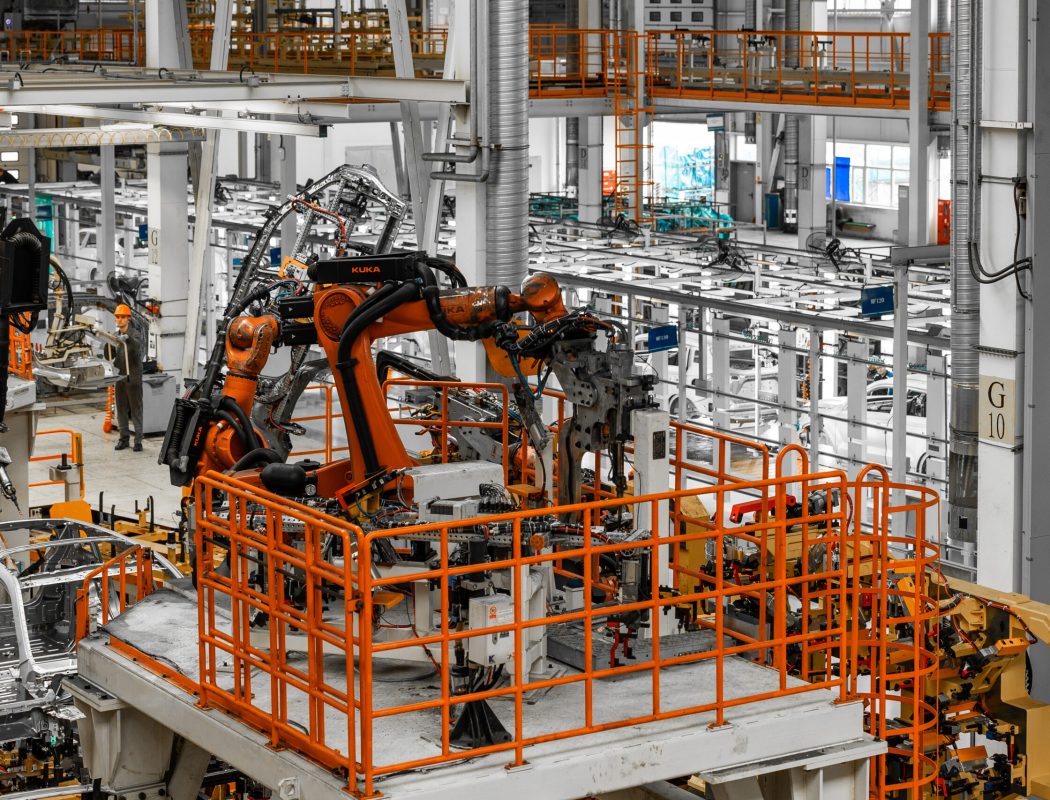 Photo of automobile production line. Welding car body. Modern car assembly plant. Auto industry. Interior of a high-tech factory, modern production.